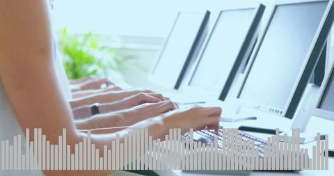 Typing together on multi-monitor workstations with audio bars enhancing team productivity