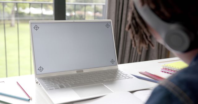 Individual working on laptop near window in workspace - Download Free Stock Images Pikwizard.com