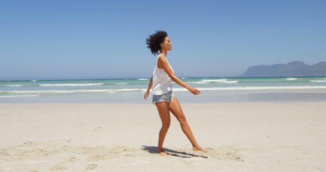 Young Woman Enjoying Walk on Sunny Beach - Download Free Stock Images Pikwizard.com