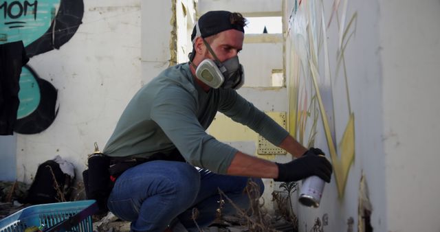 Urban Artist Wearing Respirator Graffitiing Wall in Abandoned Building - Download Free Stock Images Pikwizard.com