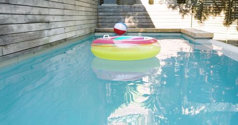 Vibrant Inflatable Swim Ring Floating in Sunlit Backyard Pool