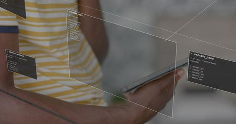 Holding smartphone with holographic AR code overlays in modern interior