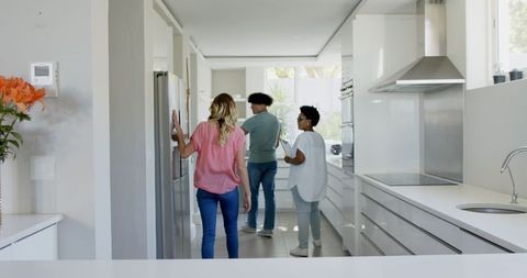 Couple exploring modern kitchen with real estate agent