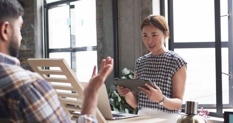 Colleague Presenting Digital Tablet in Modern Office