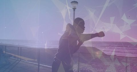 Silhouette of African American Man Boxing with Futuristic Network Overlay