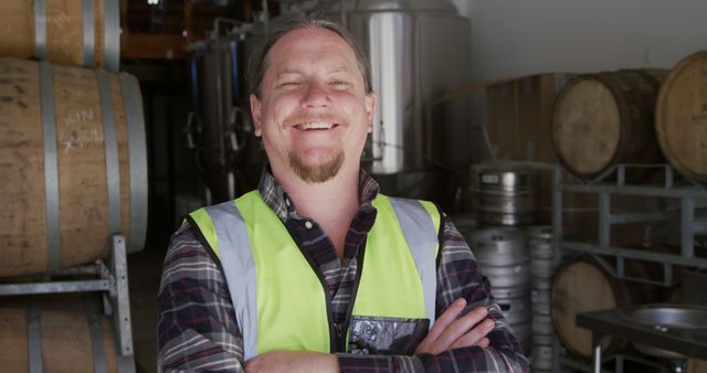 Happy Brewery Worker Wearing Safety Vest in Brewery - Download Free Stock Images Pikwizard.com