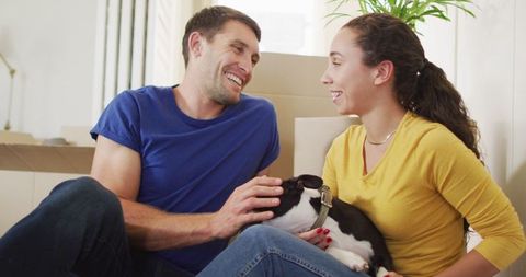 Smiling Couple Relaxing at Home with Their Dog in Cozy Living Room
