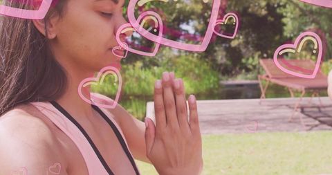 Woman Meditating with Heart Overlays in Peaceful Backyard Scene