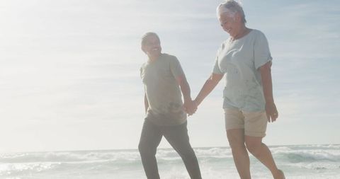 Senior Couple Enjoying a Sunset Walk on the Beach
