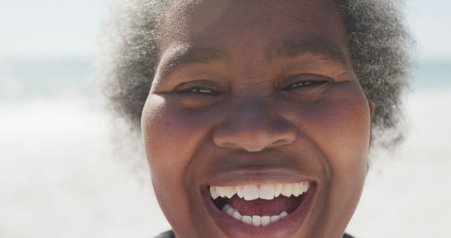 Portrait of happy senior african american woman laughing on beach - Download Free Stock Photos Pikwizard.com