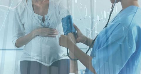 Pregnant patient receiving blood pressure monitoring from nurse with data overlay