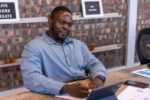 Focus and Determination: Business Professional Analyzing Reports at Desk