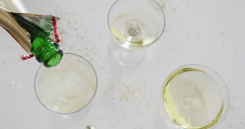Pouring Champagne in Glasses with Festive Sparkles - Download Free Stock Images Pikwizard.com