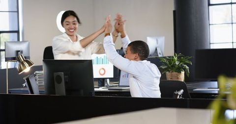 Multiracial Business Colleagues Celebrating Success with High Five