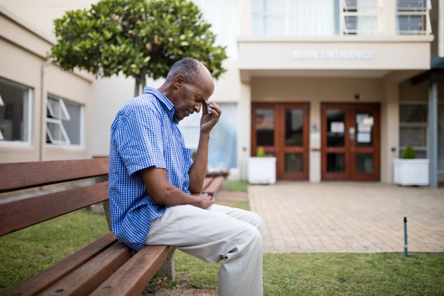 Sad Senior Man Sitting on Bench Outside Nursing Home - Download Free Stock Photos Pikwizard.com