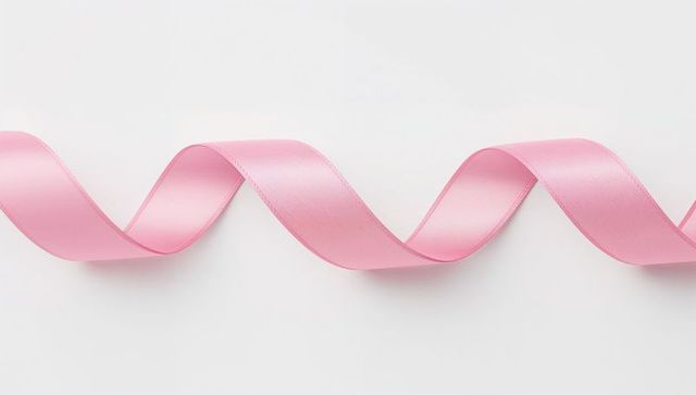 Elegant flowing pink ribbon on minimal white background
