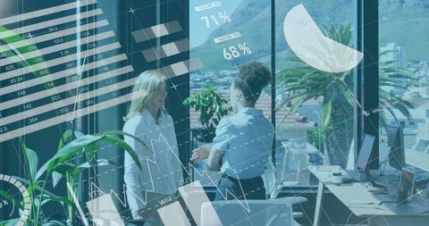 Businesswomen exchanging data insights in modern office