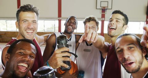 Diverse Basketball Team Celebrating Victory in Gymnasium - Download Free Stock Images Pikwizard.com