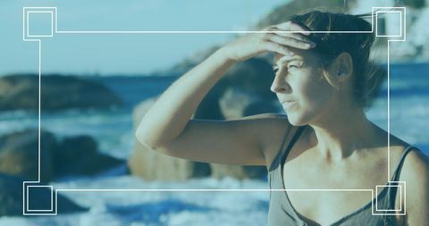 scene depicts a woman gazing thoughtfully towards the horizon at a beach. used for relaxation, travel blogs, mental health, or advertising for sporting and retail markets. updated lifestyles or nature aesthetics can benefit from highlighting human connection with nature.