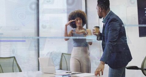 Business colleagues discussing strategy in modern office gesturing woman speaking over coffee