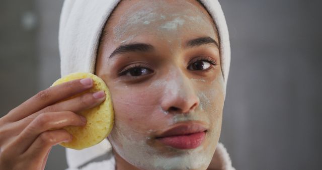 Young Woman Applying Face Mask with Sponge for Skincare Routine - Download Free Stock Images Pikwizard.com