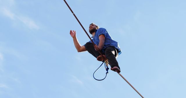 Man Walking on Tightrope Against Clear Blue Sky - Download Free Stock Images Pikwizard.com