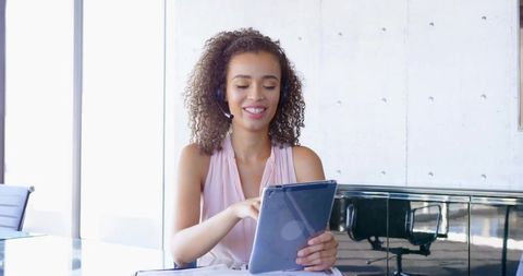 Smiling Professional Using Tablet in Modern Office Environment