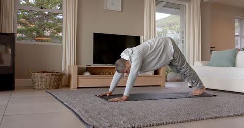 Senior Practicing Yoga at Home