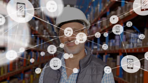 Senior Male Supervisor with Digital Network Interface in Warehouse