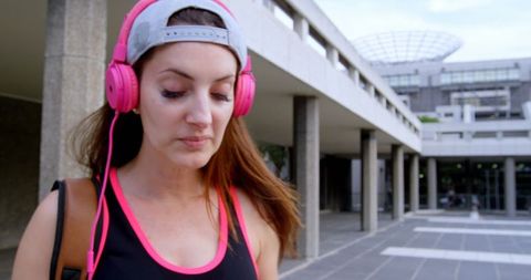 Caucasian Female Street Dancer Walking City with Pink Headphones - Download Free Stock Images Pikwizard.com