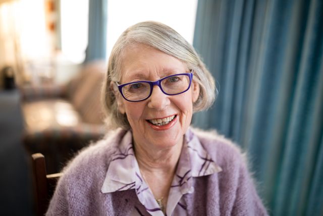 Portrait of cheerful senior woman wearing eyeglasses at nursing home