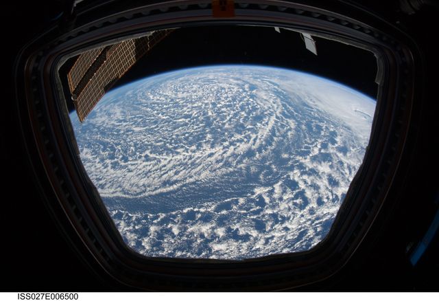 Earth view from the Cupola of the International Space Station on 20 March 2011 showing a low pressure system in the North Pacific Ocean. The image depicts swirling clouds and atmospheric patterns typical of low pressure conditions, showcasing Earth's natural weather phenomena. Ideal for educational content, atmospheric studies, space-themed projects, and illustrating Earth's beauty from space.