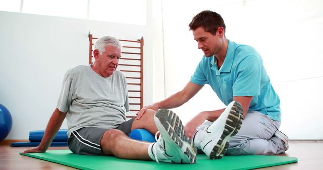 Physiotherapist helping patient with his knee mobility at the rehabilitation center 