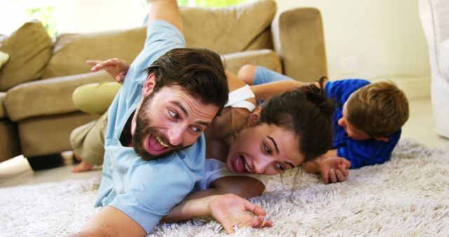 Happy family playing on the carpet together at home