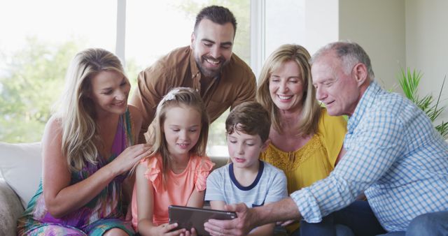 Happy Multi-Generational Family Enjoying Tablet Together in Living Room - Download Free Stock Images Pikwizard.com