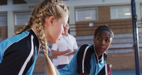 Teen Girls Engaged in Teamwork at School Gym