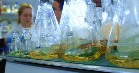 Colorful Chemical Solutions in Laboratory with Animated Formulas