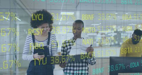 Diverse Colleagues Analyzing Digital Financial Data in Modern Office