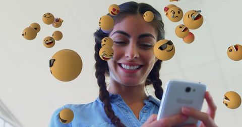 Smiling Woman Enjoying Social Media with Floating Emojis