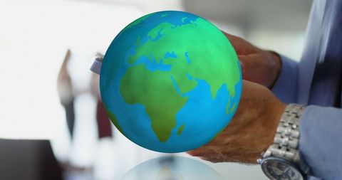 Man Holding Globe Representing Global Connectivity and Innovation