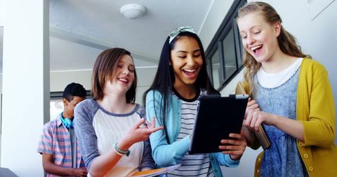 Cheerful School Friends Using Tablet in Hallway - Download Free Stock Images Pikwizard.com