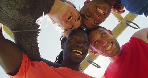 Diverse Group Huddling for Team Unity and Motivation Outdoors