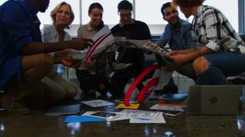 Diverse Team Collaborating on Creative Project with Digital Interface