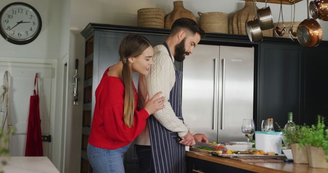 Image of happy caucasian couple cooking in the kitchen. Domestic lifestyle and leisure at home.