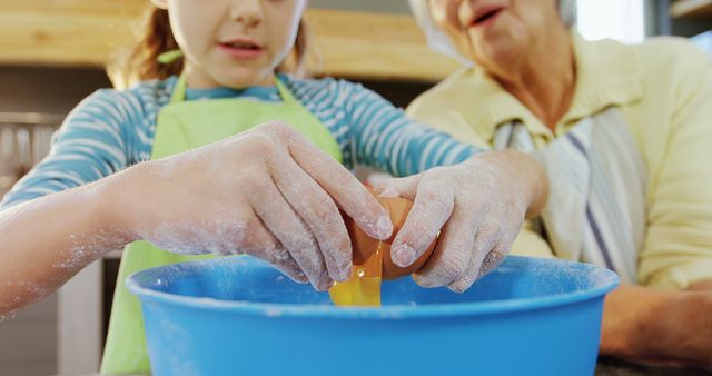 Grandmother and Granddaughter Cracking Egg in Kitchen - Download Free Stock Images Pikwizard.com