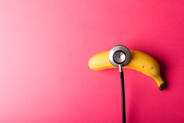 Stethoscope on Banana Against Red Background - Download Free Stock Photos Pikwizard.com
