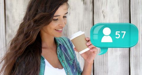 Woman enjoying coffee with social media notification outdoors
