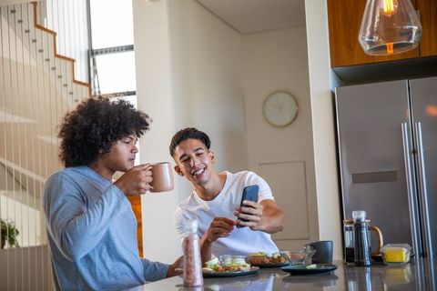 Friends Sharing Moments While Enjoying Breakfast in Modern Kitchen