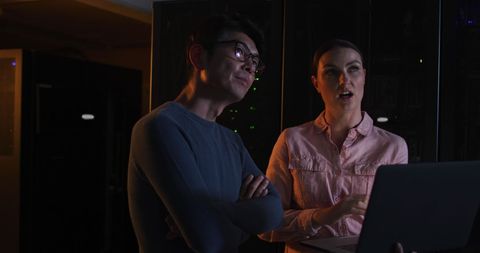 Engineers Collaborating in Dimly Lit Server Room - Download Free Stock Images Pikwizard.com