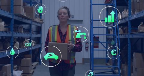 Warehouse worker carrying box in smart logistics hub displaying sustainability icons